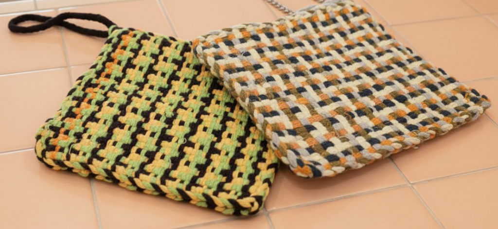 Checkered potholders on a pink surface 