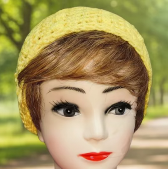 Mannequin head with a yellow headband in a park setting