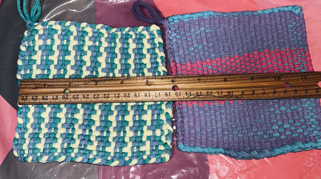Two woven potholders with a ruler for scale on a colorful background