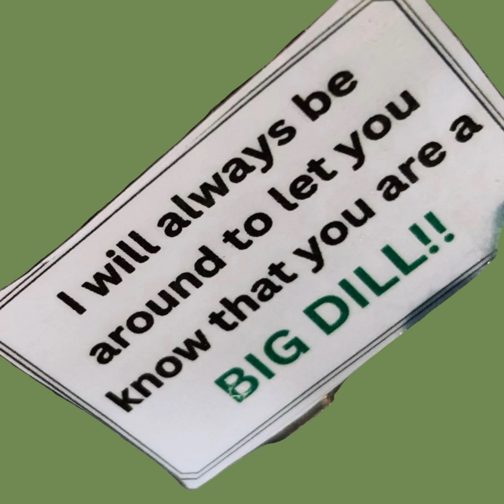 Green plush toy with a label on a textured surface