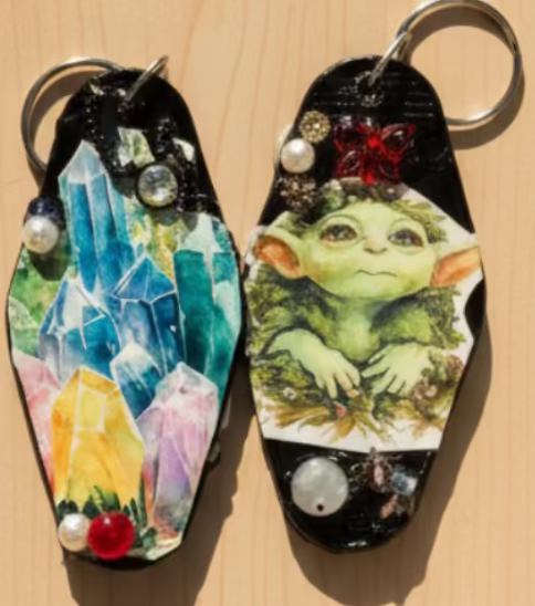 Two keychains with decorative elements on a wooden surface