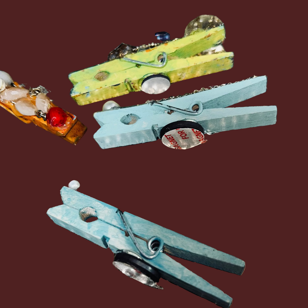 Colorful clothespins on a textured metal surface