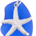 Blue sea glass pendant with a silver starfish charm on a white background