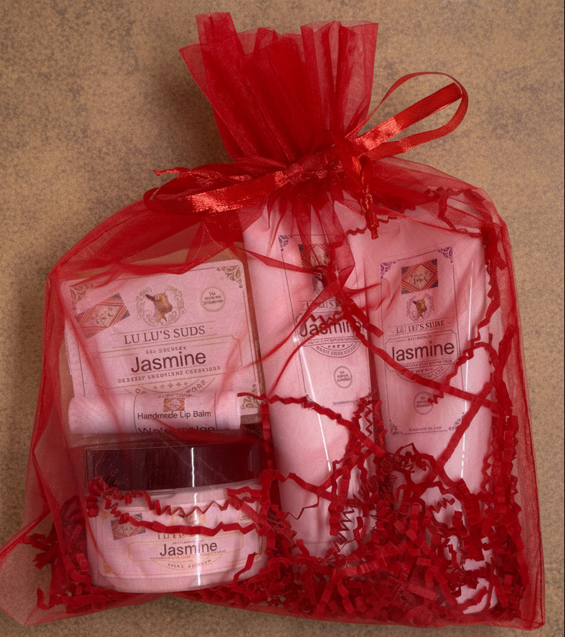 Set of Jasmine-themed skincare products in a red cellophane bag on a white background