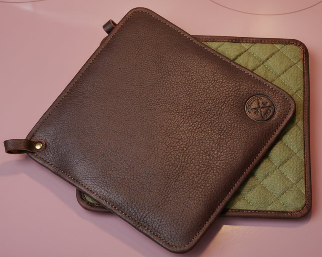 Brown leather pouch with green quilted interior on a white background