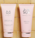 Two pink tubes of Delina body cream and shower gel with Parfums de Marly logo on a white background.