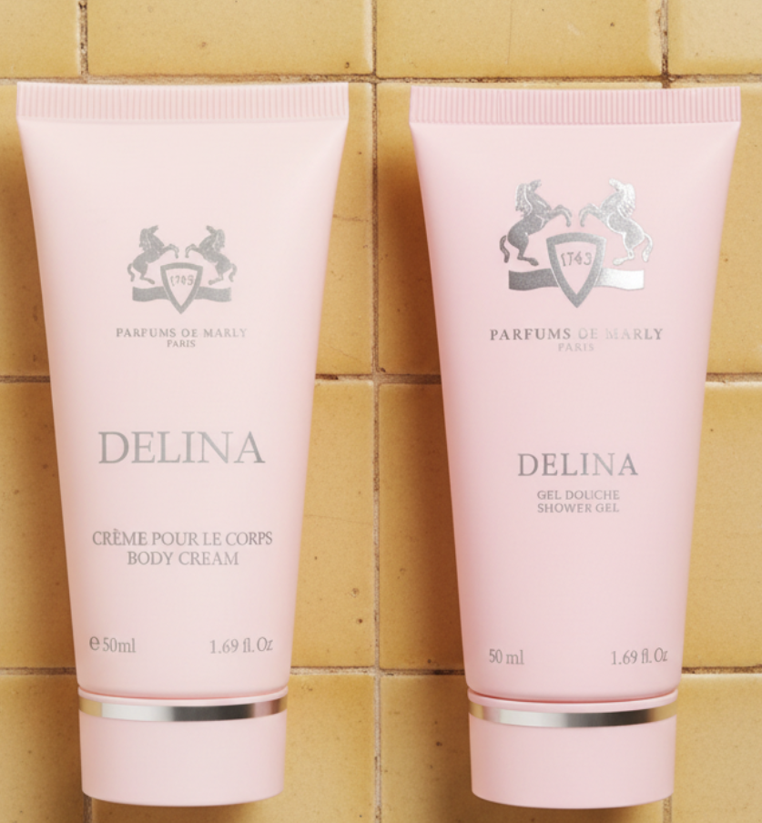 Two pink tubes of Delina body cream and shower gel with Parfums de Marly logo on a white background.