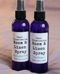 Two bottles of odor eliminating room and linen spray on a white background
