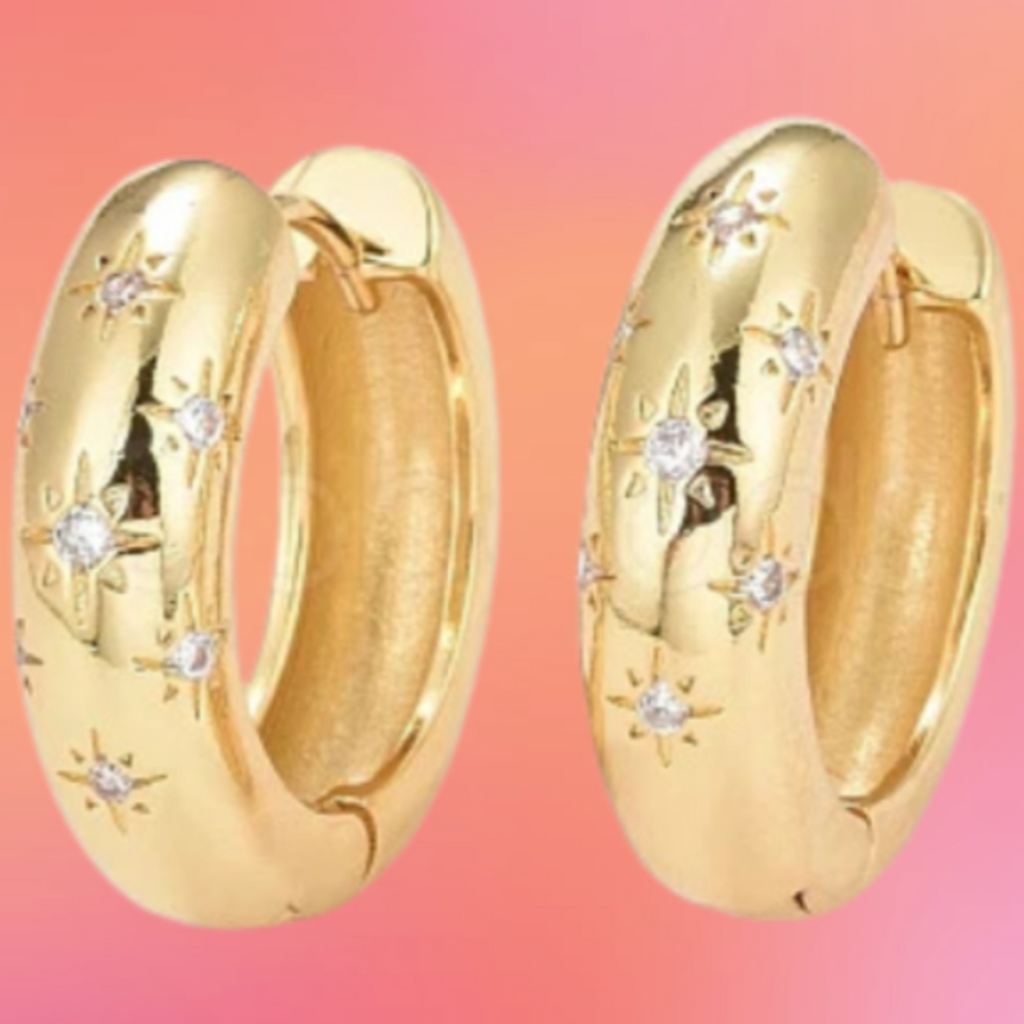 Gold hoop earrings with embedded stones on a colorful gradient background