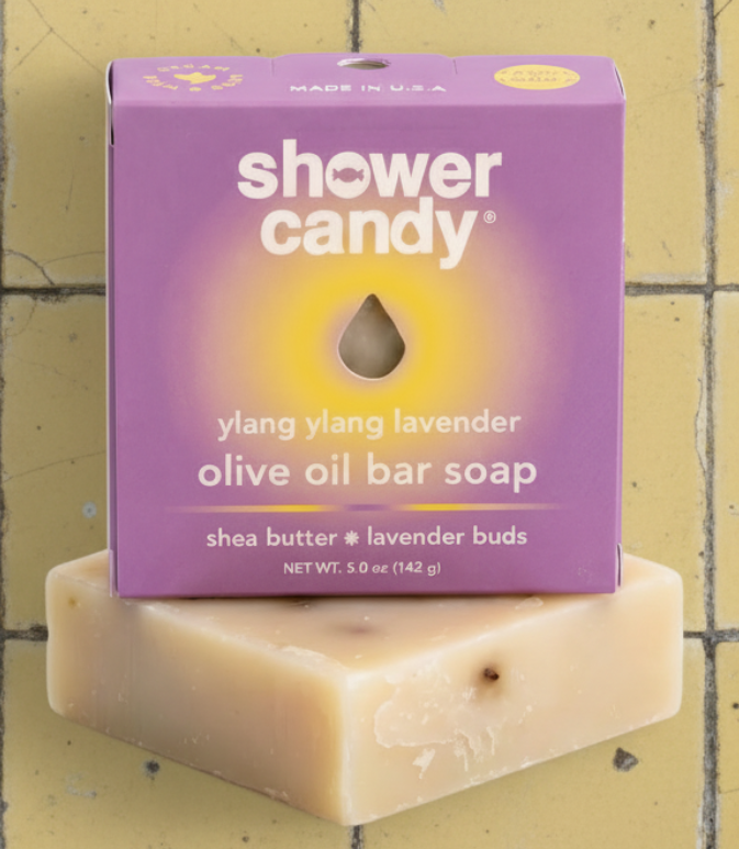Shower candy olive oil bar soap with purple packaging on a white background