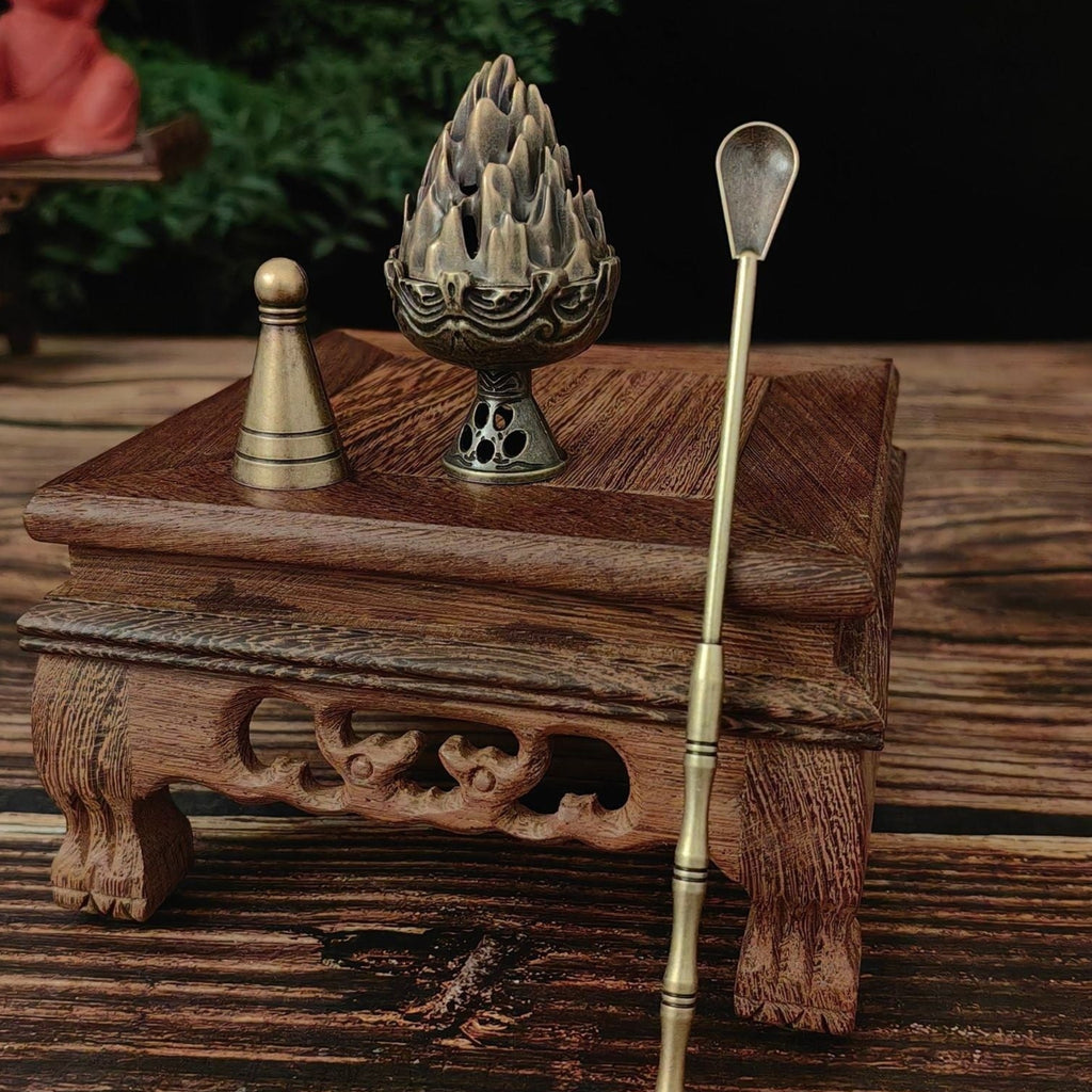 Incense burner with incense stick on a wooden surface