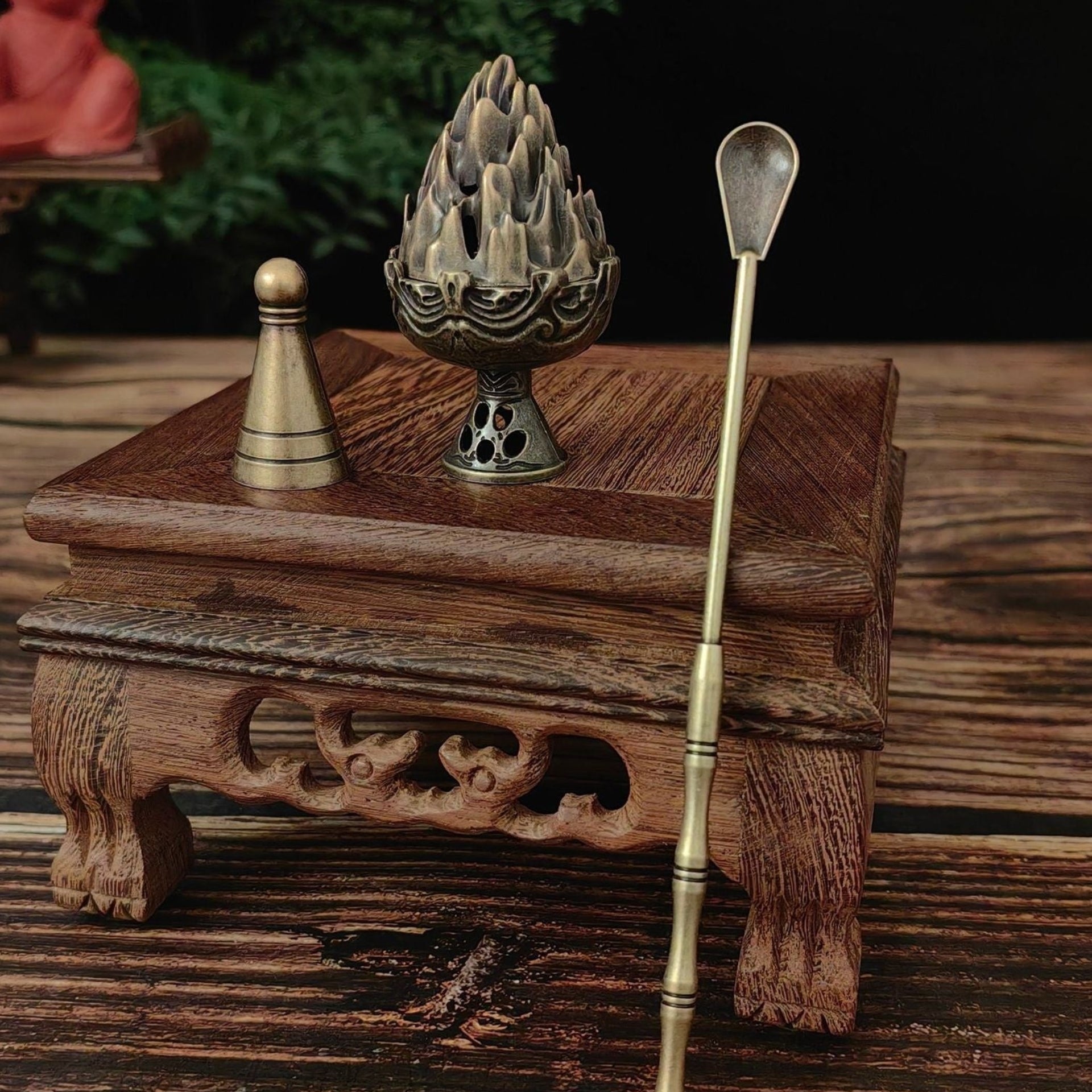 Incense burner with incense stick on a wooden surface