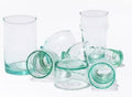 Set of green glass tumblers on a white background