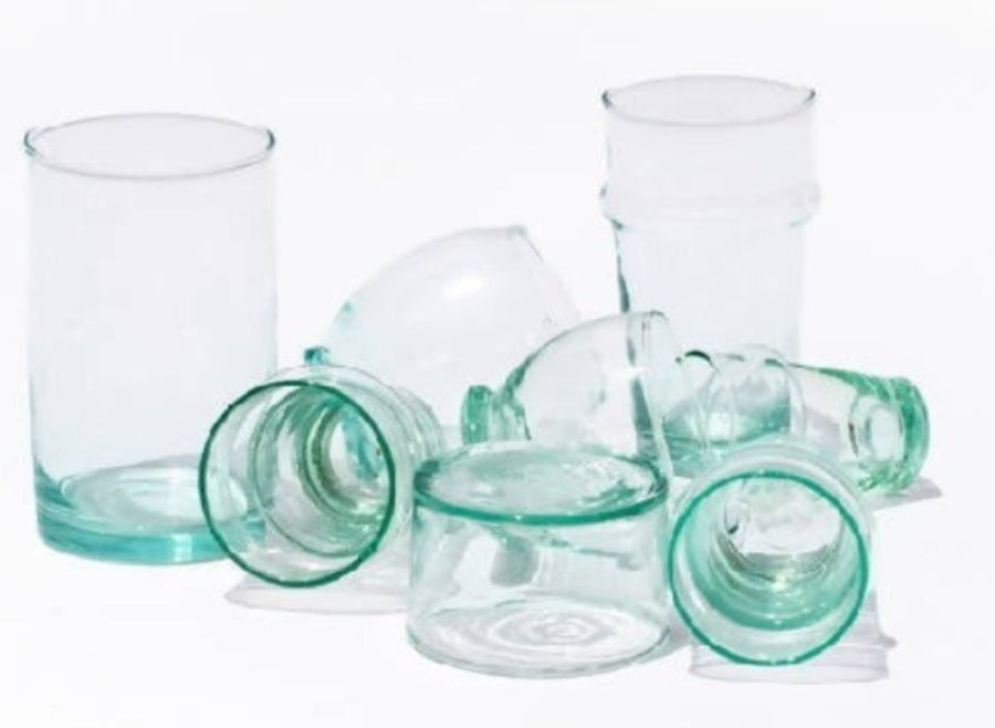 Set of green glass tumblers on a white background