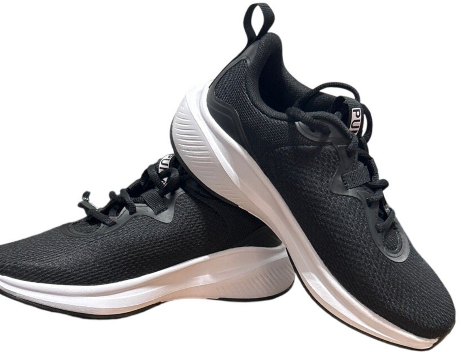 Black running shoes with white soles on a white background