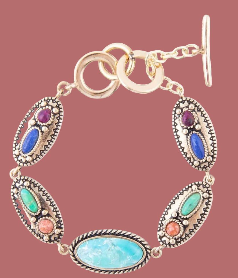 Multicolored gemstone bracelet with gold accents on a white background