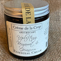 Jar of Crème de la Crop essential cream on a burlap background