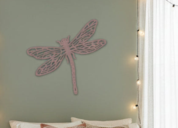 Gold dragonfly-shaped decorative item on a white background