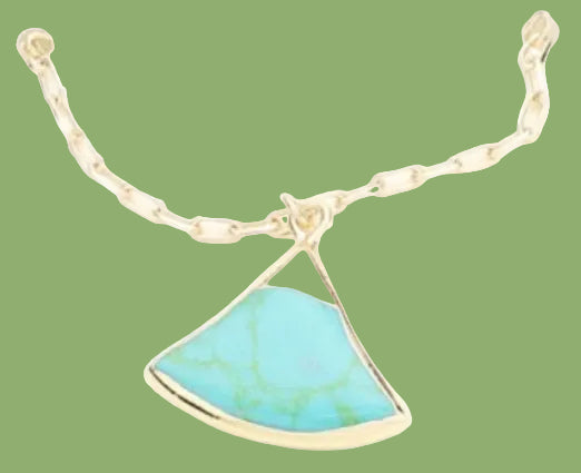 Gold necklace with a turquoise pendant on a white background