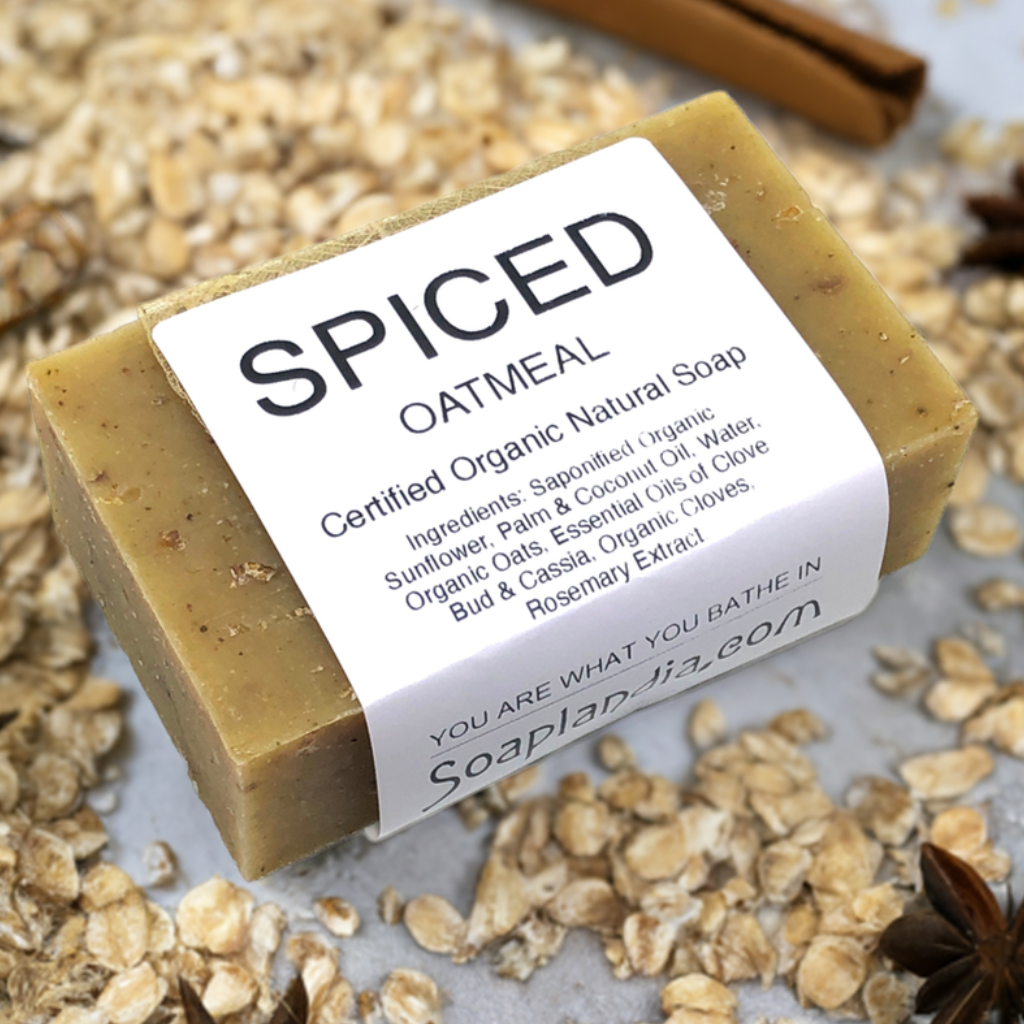 Spiced oatmeal soap bar with ingredients on a light background