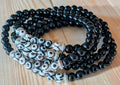 Black and white beaded bracelet on a wooden surface