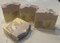 Three bars of soap with a marbled pattern on a light surface