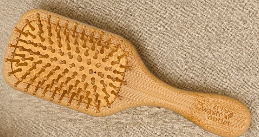 Wooden hairbrush with textured surface on a beige fabric background