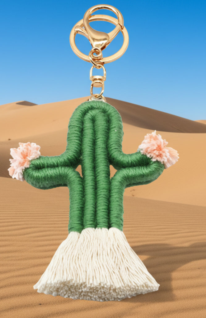 Cactus-shaped keychain with tassel on a white background