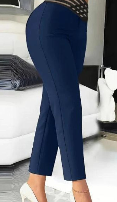 Person wearing navy blue pants in a modern room setting